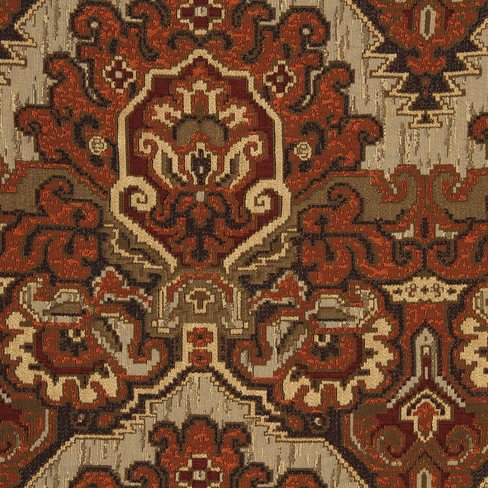 Saffron-colored upholstery fabric swatch with a Persian-style arabesque floral medallion pattern in red, ivory and brown; rectangular sample.