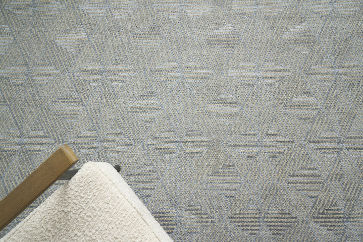 Light gray flat-weave rug with a geometric triangular pattern, 5' x 8'.