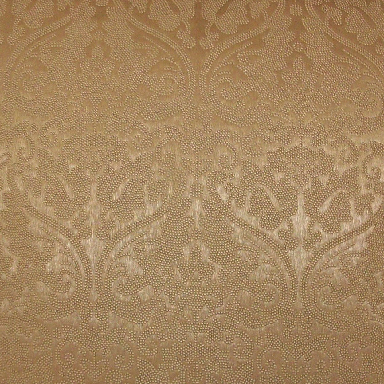 Beige damask fabric with ornate scrolling floral pattern; woven, elegant upholstery textile.