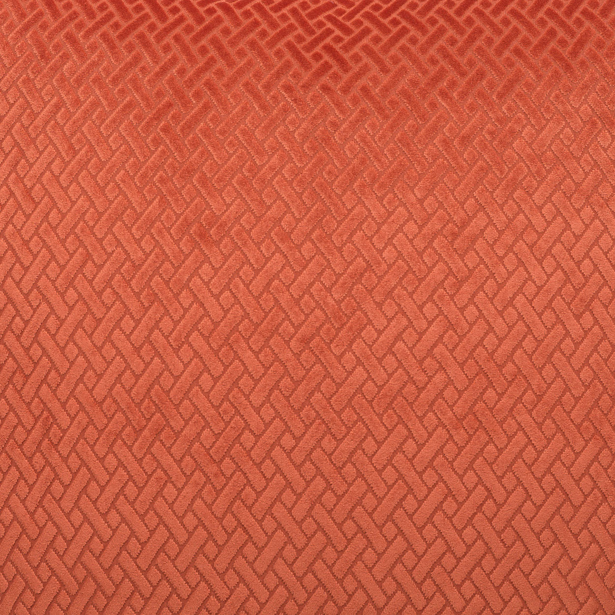 Rust-orange woven fabric with a repeating basket-weave pattern and textured upholstery-ready surface.