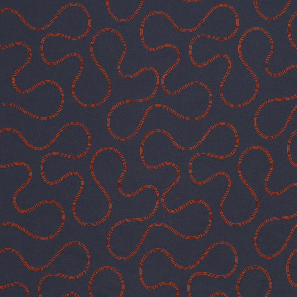 Navy upholstery fabric with a repeating red curvy loop pattern; modern graphic textile.