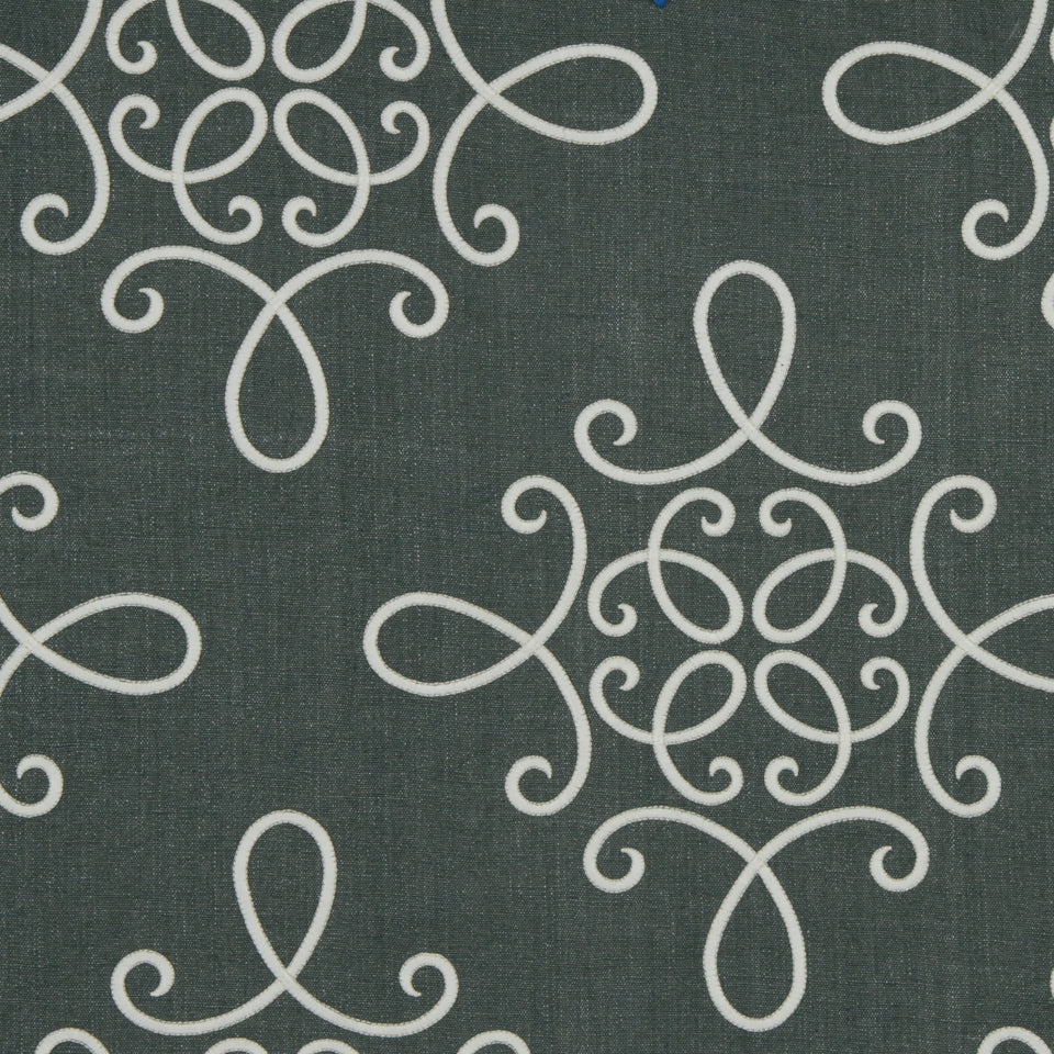 Dark teal fabric with white scrolling damask pattern; decorative upholstery or drapery textile.