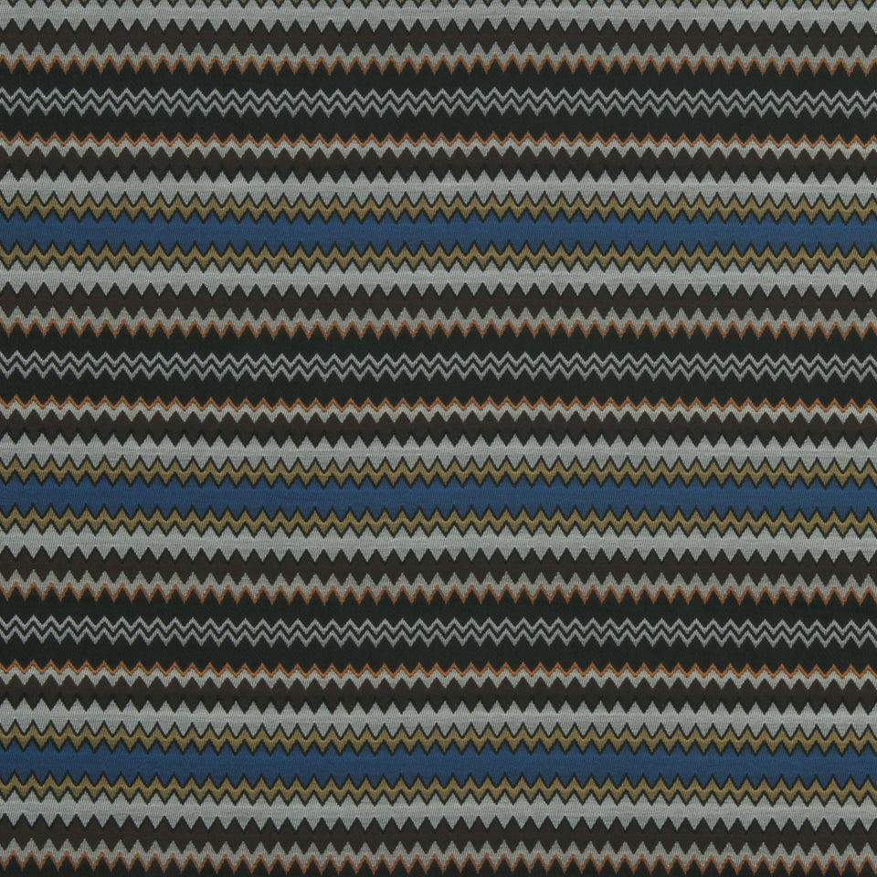 Woven fabric with thin zigzag chevron stripes in charcoal, gray, rust, blue and gold.
