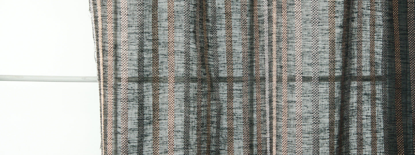 Close-up of grey & black striped woven curtain fabric with subtle beige accents, textured drapery.