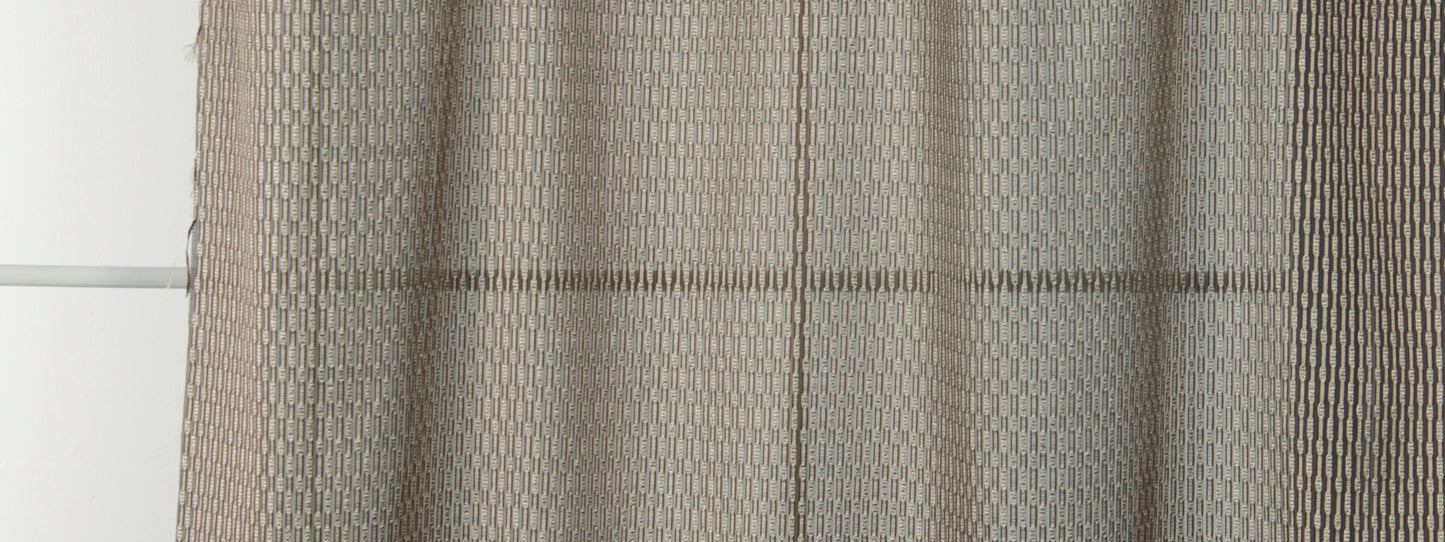 Beige woven curtain panels with a subtle geometric honeycomb pattern and soft drape.