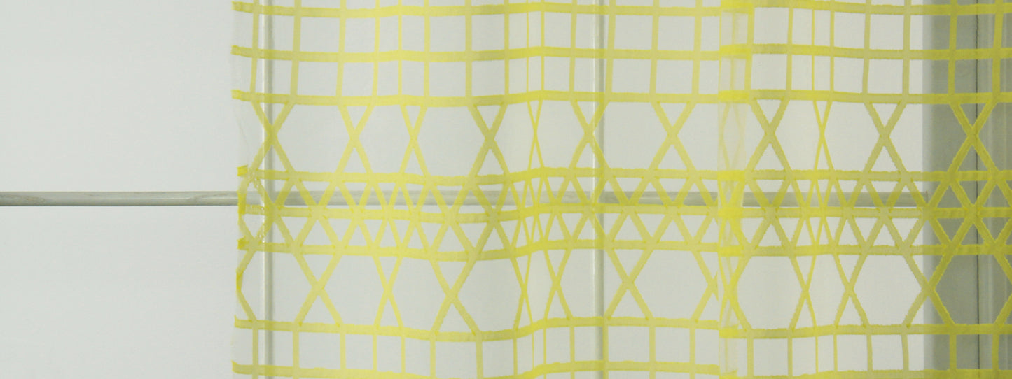Citron triangle-grid drapery fabric with a geometric triangle pattern.