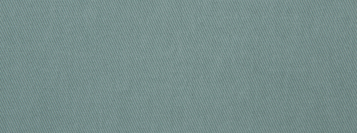 Teal-blue denim-like twill fabric close-up with diagonal weave texture.