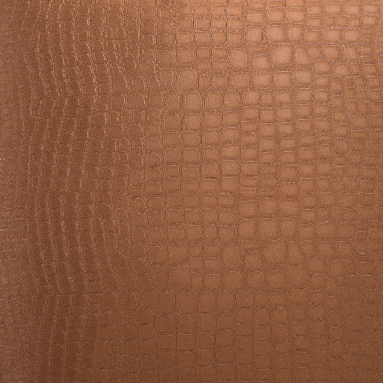 Brown crocodile-embossed leather texture close-up.