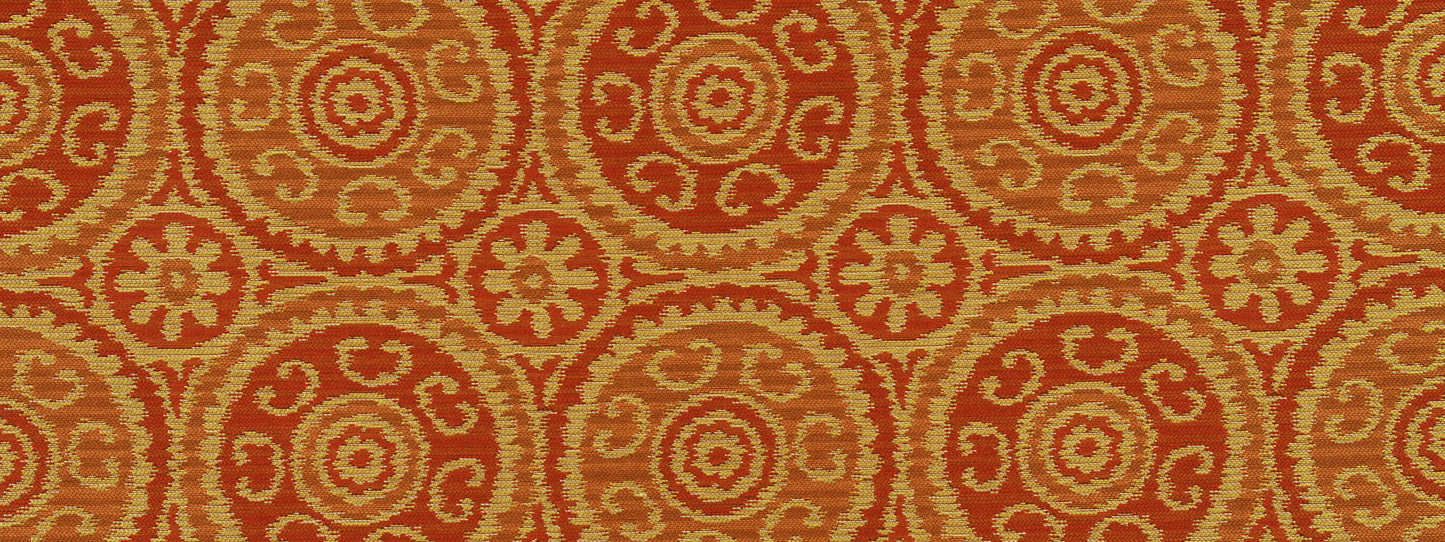 Orange and tan circular medallion pattern upholstery fabric with repeating rosette motifs.