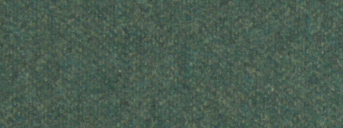 Close-up of a green textured upholstery fabric surface with dark and light flecks.