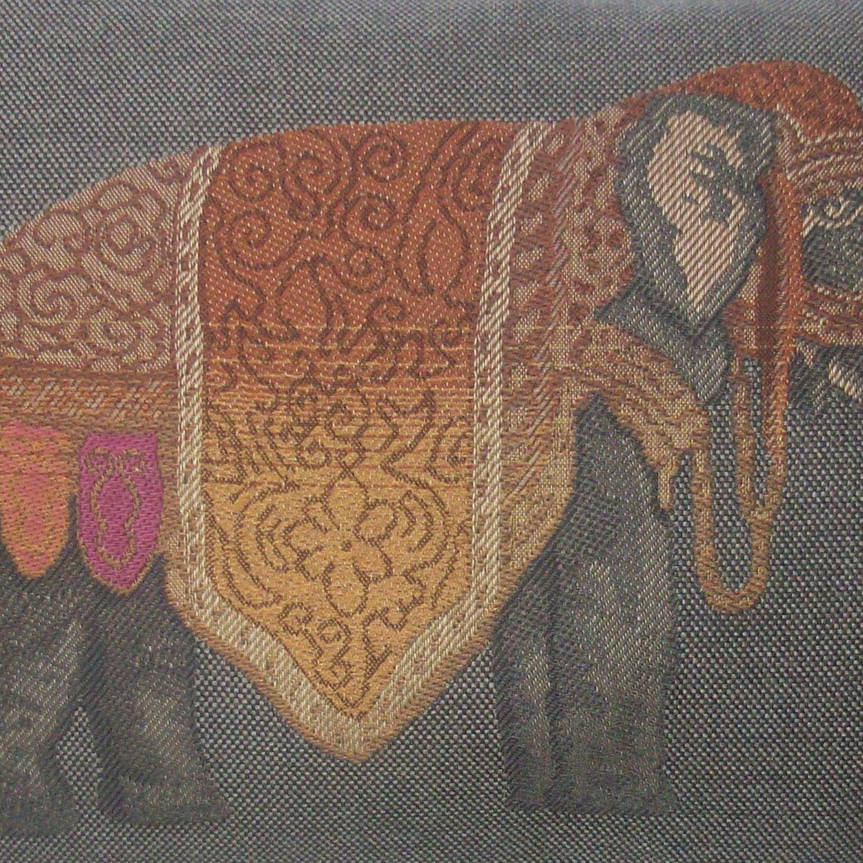 Lumbar pillow with orange-gold ornate elephant motif on gray background; woven textile, 14" x 24