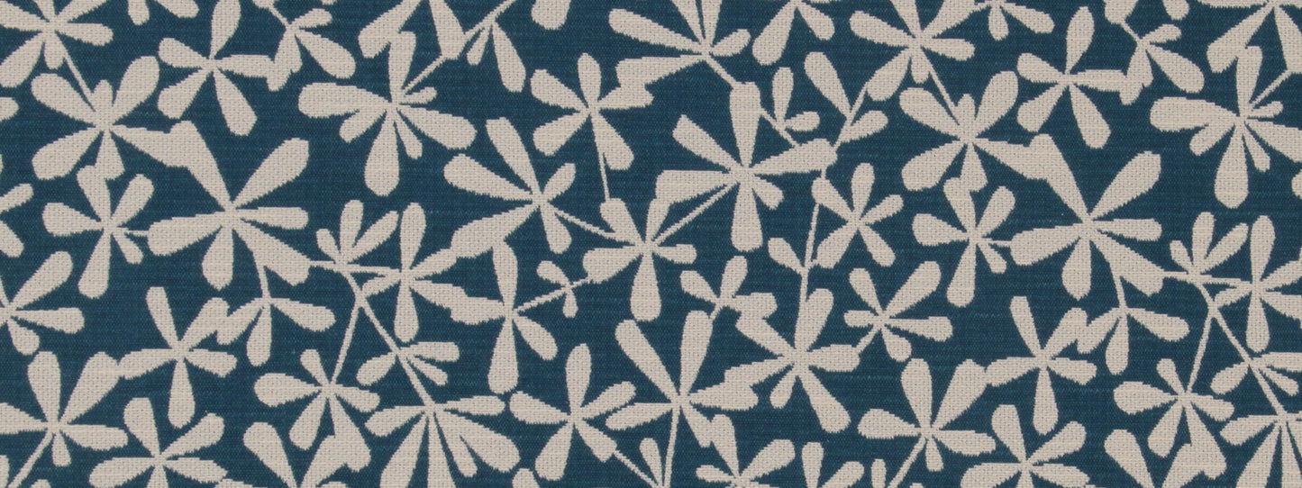Blue background with dense white pinwheel floral pattern; starburst flowers across the surface.