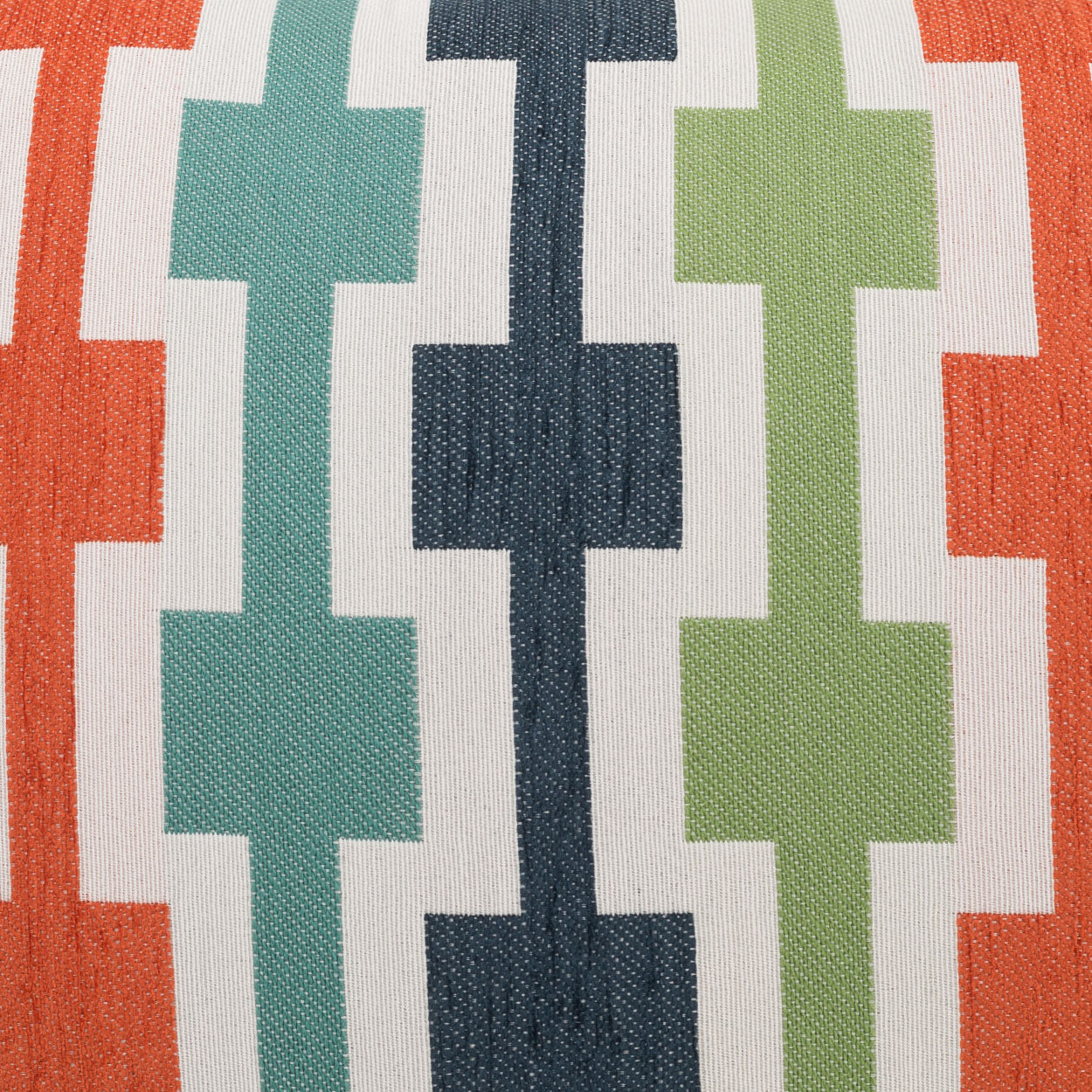 Pillow with a woven textile featuring repeating vertical cross motifs in orange, teal, navy and lime on white, 24" x 24