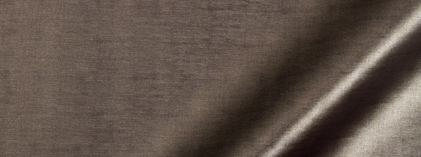 Close-up of brown linen-like fabric with a diagonal light highlight and subtle weave.