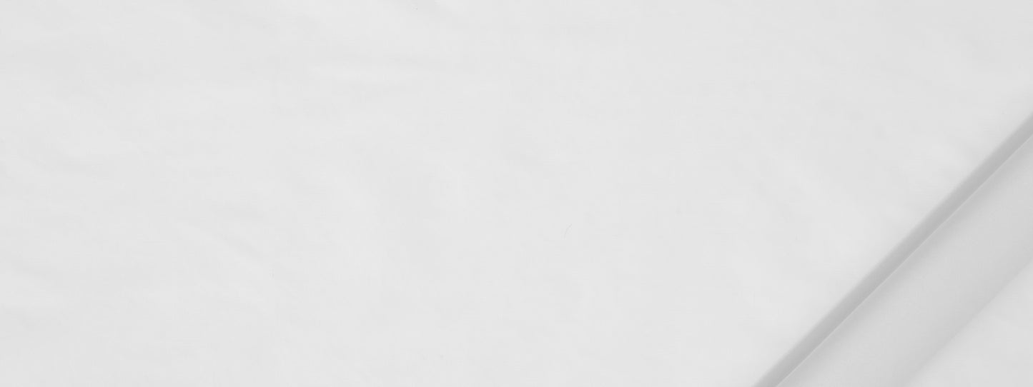White fabric with soft folds and a diagonal crease along the top-right.
