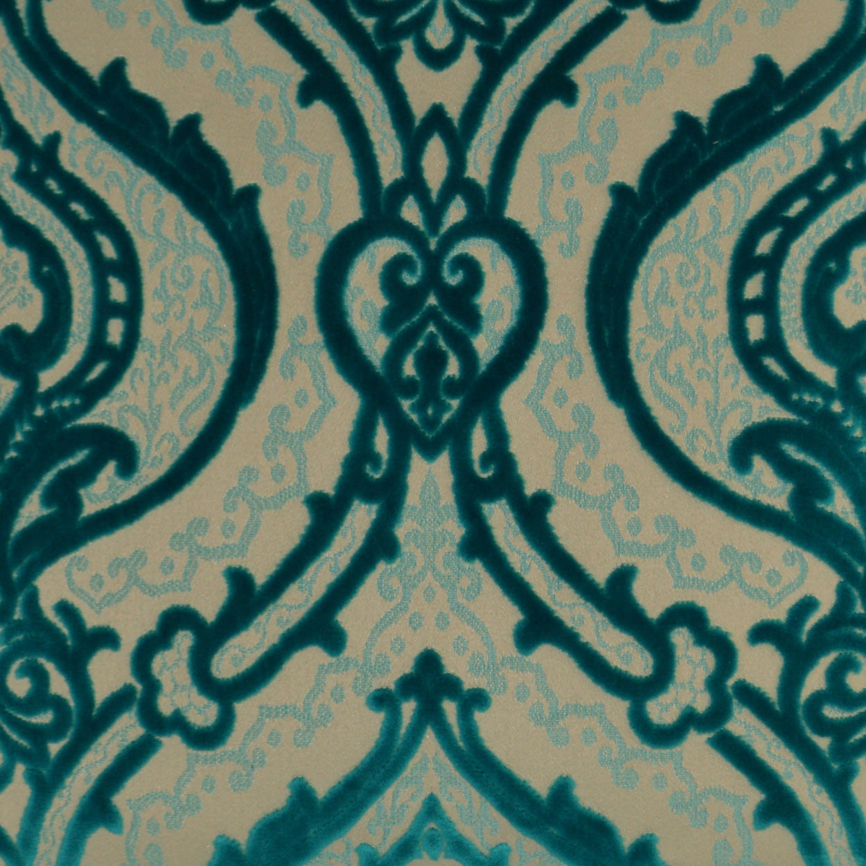 Teal damask pattern on beige fabric with ornate scrolling motifs.