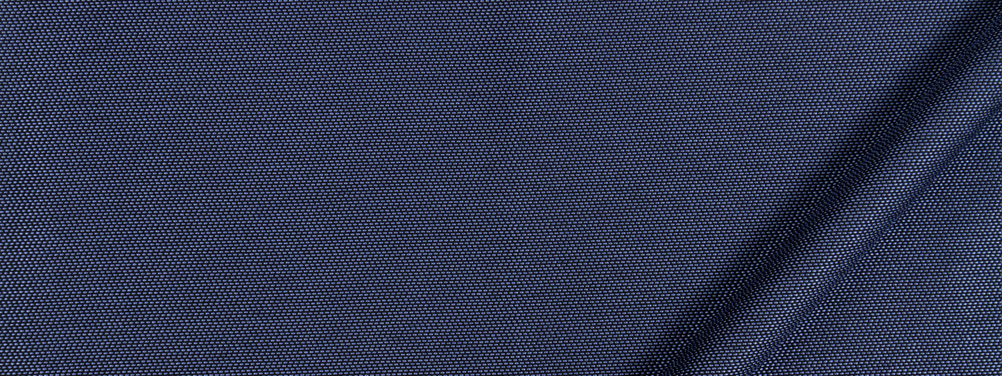 Close-up of navy blue fabric with a fine dotted weave and a diagonal seam across the corner.