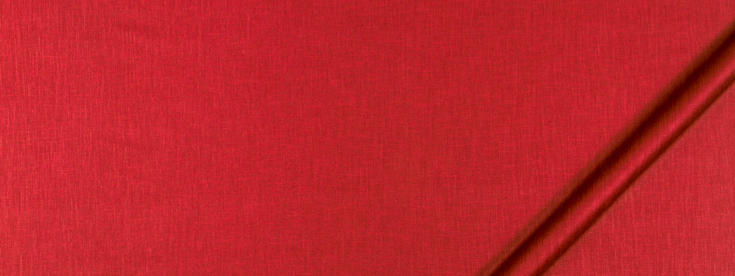 Bright red fabric texture with a slim brown rod diagonally across the top-right corner.