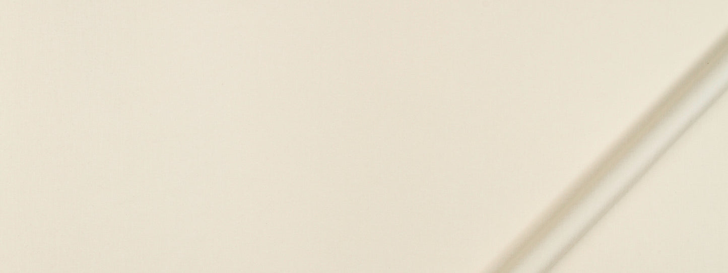 Cream fabric swatch with a subtle texture; a slim diagonal chrome rod crosses a beige background.