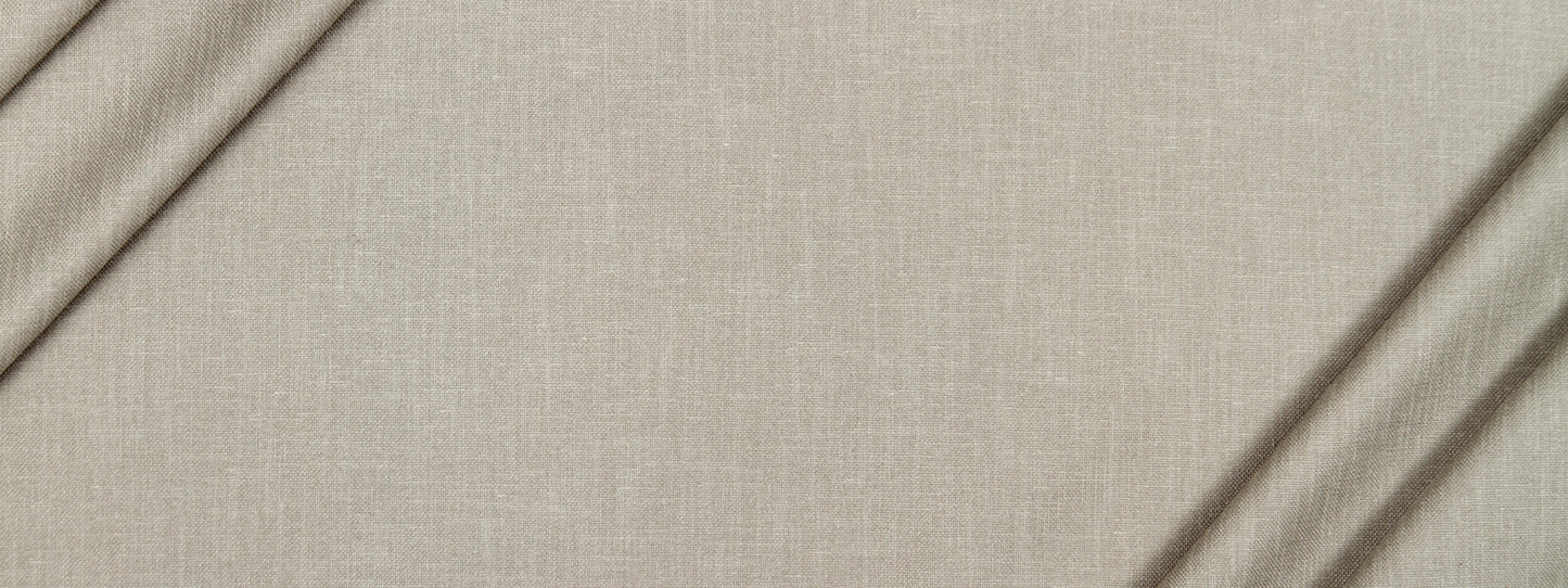Beige linen fabric close-up with visible weave and soft folds.