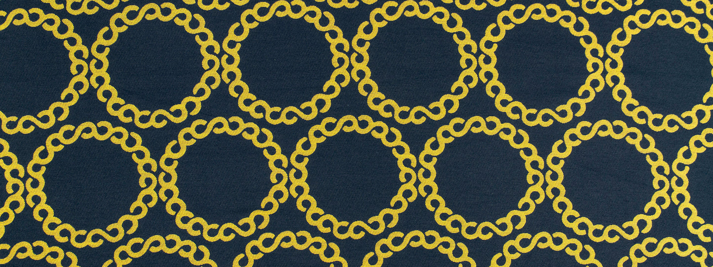Slate upholstery fabric with a repeating gold chain-link circular ring motif.