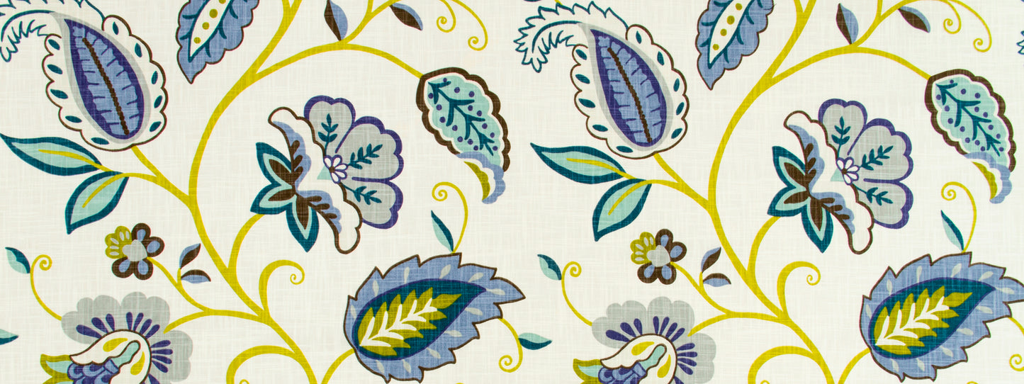 Vibrant botanical fabric pattern with blue, teal and yellow leaves and swirling vines on white background.