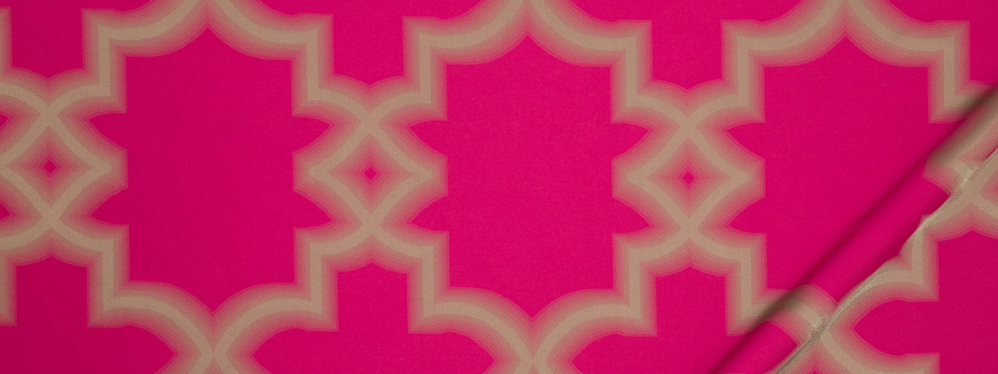 Bright pink fabric with cream interlocking quatrefoil lattice pattern; bold Moroccan-inspired textile.