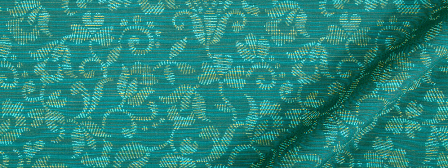 Teal woven fabric with an off-white floral damask pattern and folded corner.