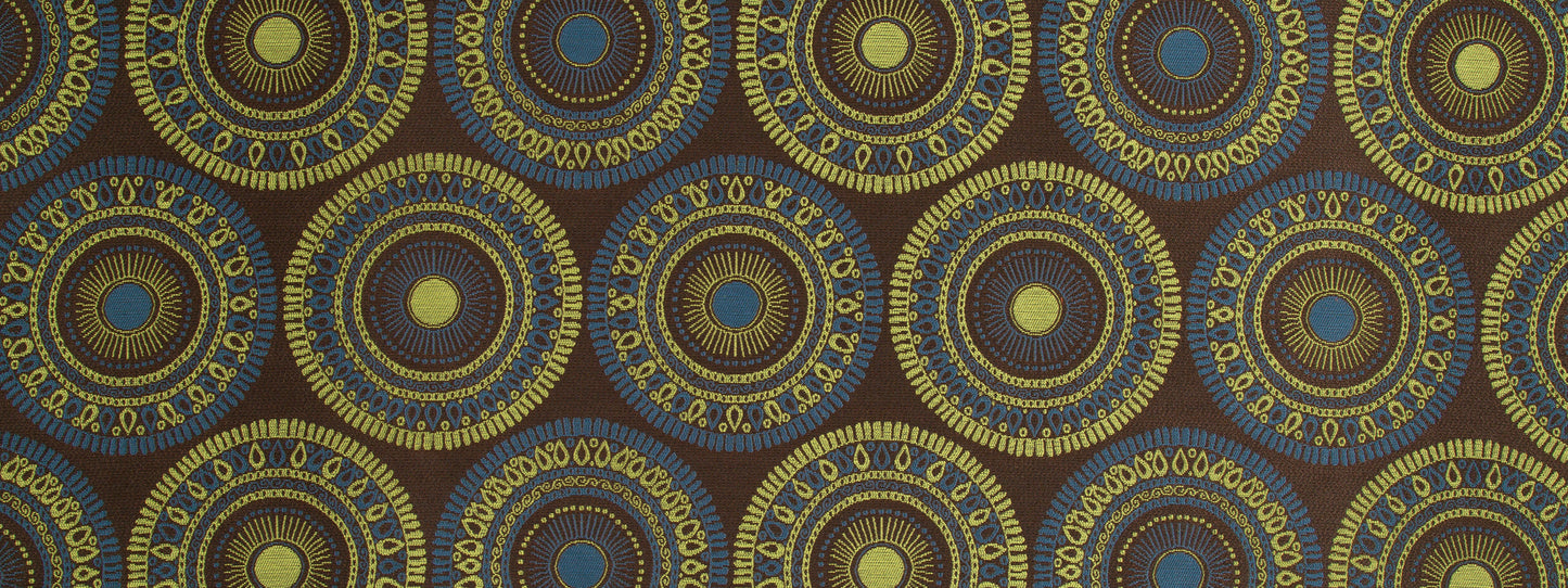 Repeating circular mandala pattern in blue and gold on a dark brown fabric background.