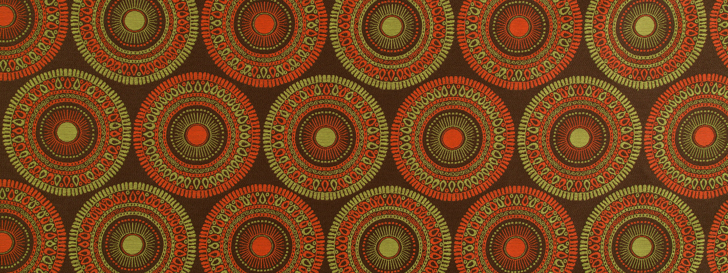 Bohemian circular medallion textile print in orange and olive on a dark brown background; repeating upholstery fabric pattern.