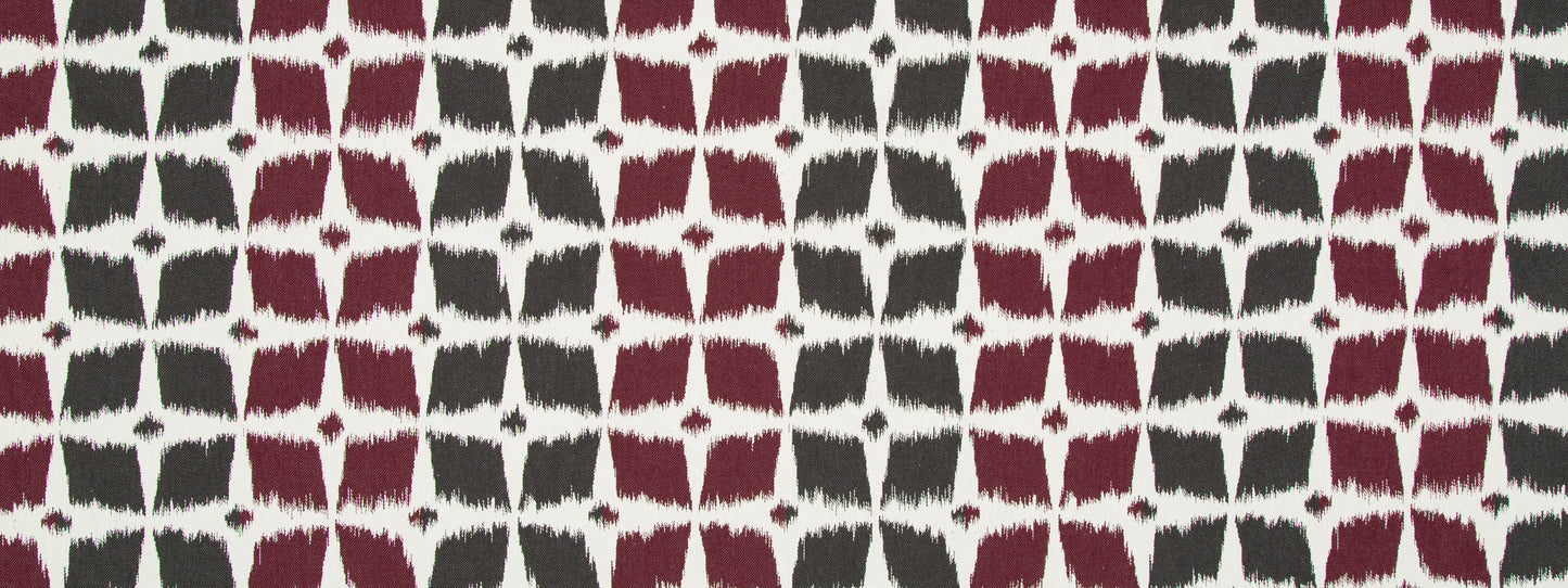 Textile featuring a repeating burgundy and charcoal quatrefoil grid on ivory background.