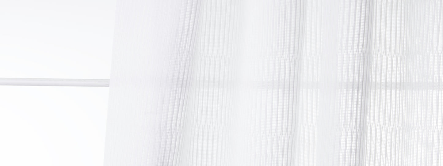 Bone-colored sheer voile curtains with soft vertical folds, airy light-filtering window drape.