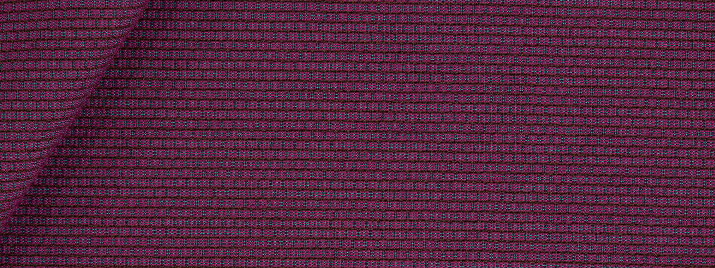 Close-up of plum purple woven upholstery fabric with a tiny pink grid pattern; dense micro-check texture, folded corner.