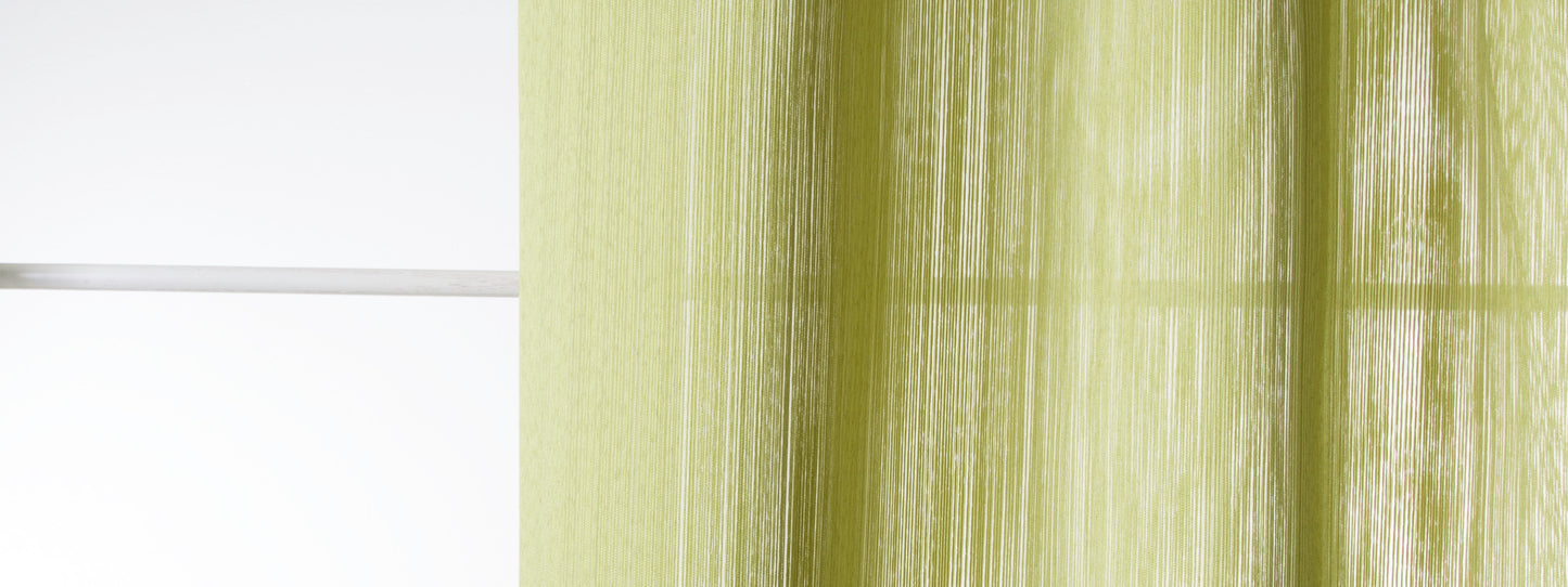 Lime-green sheer curtain with vertical folds beside a white window frame.