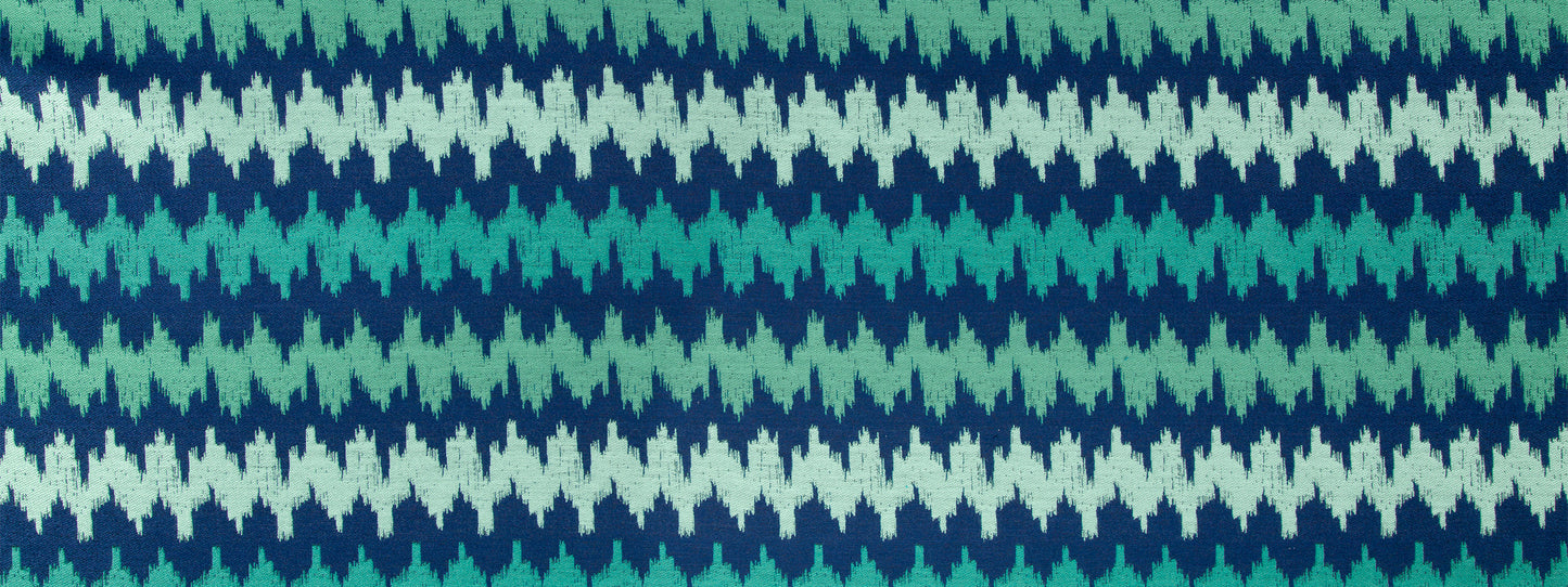 Upholstery fabric in Calypso Blue with a teal, turquoise and navy chevron pattern.