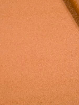 Close-up of peach-orange faux leather texture with visible grain and edge seam.