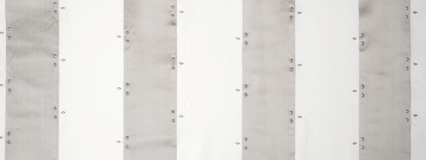 Vertical white and light-gray striped drapery panels in silver tones.