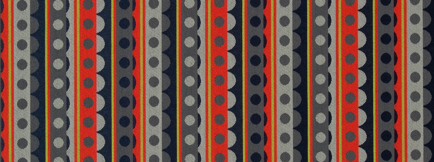 Geometric striped fabric design with vertical rows of circles in red, navy, gray and black; bold retro textile.