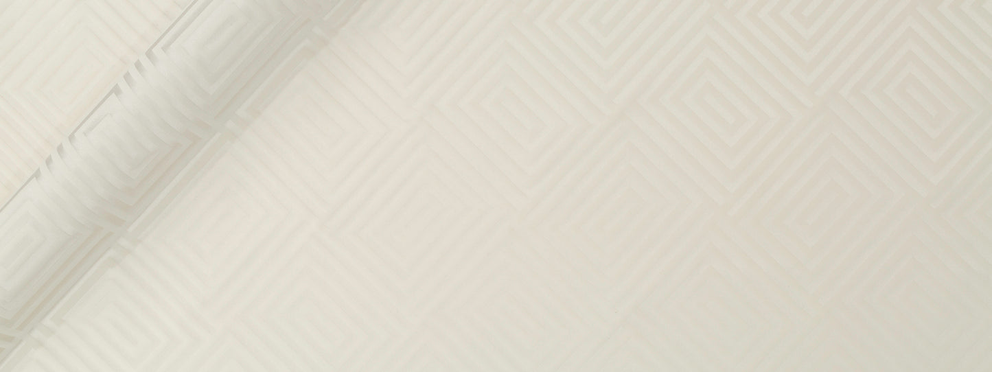 Cream textured upholstery fabric with a subtle diamond pattern and a soft fold along the left edge.