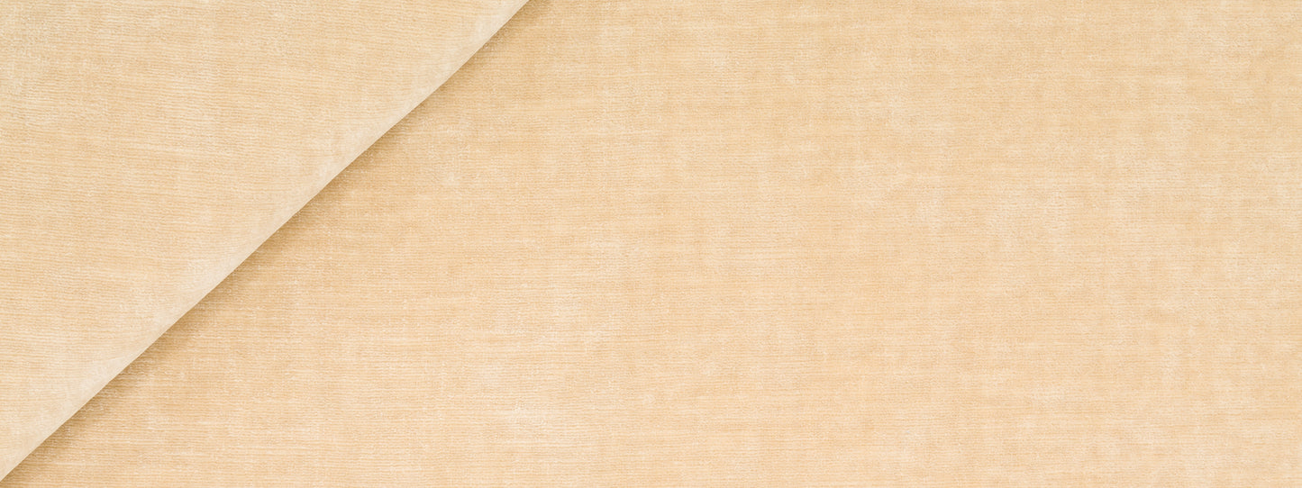 Beige velvet upholstery fabric with a diagonal fold, soft texture and natural look.