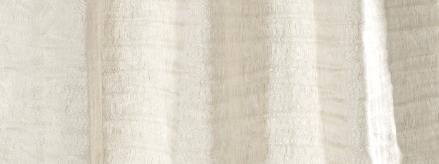 Cream linen-style fabric close-up with ribbed texture and soft folds.