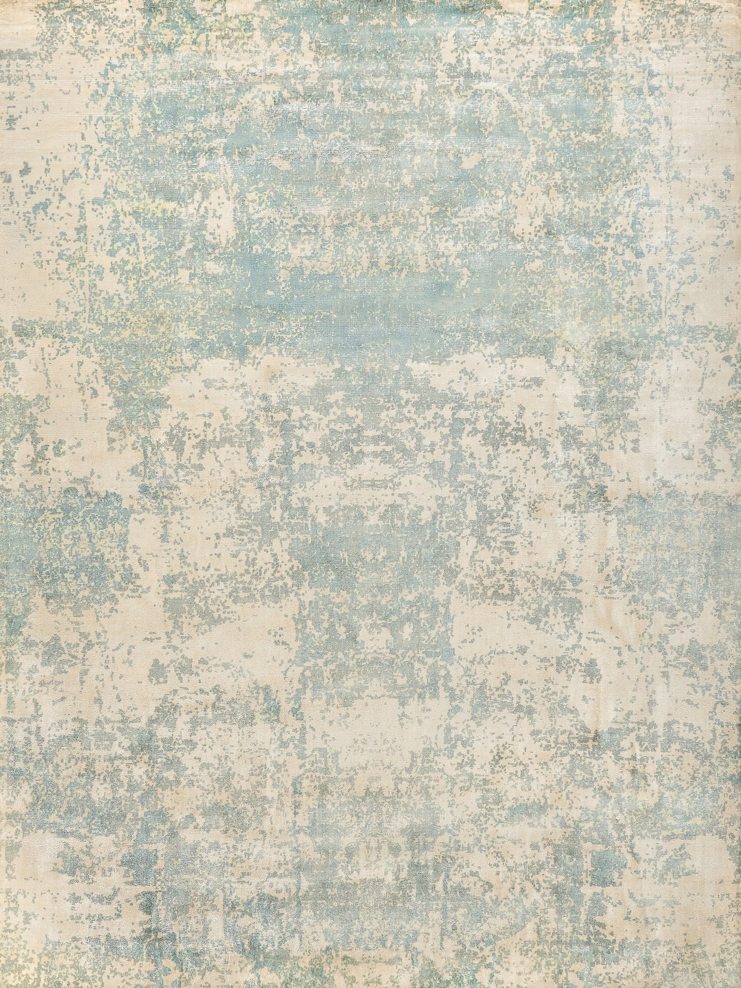 Textured rug featuring a soft, muted blue and beige color palette with a distressed, vintage appearance.