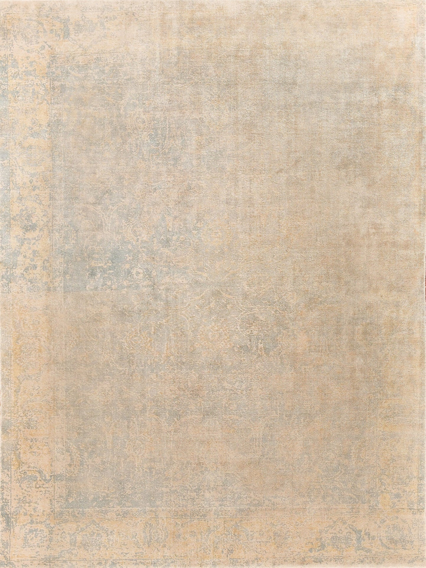 Rectangular beige rug with a softly faded blue-gray traditional motif and distressed vintage look.