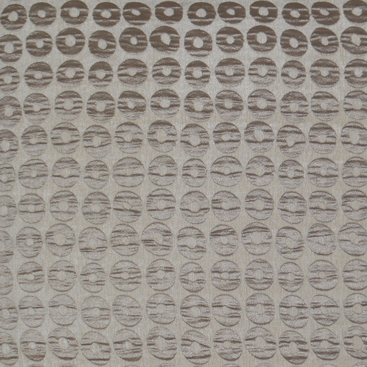 Beige fabric with repeating brown circular-ring pattern; textured textile for upholstery or drapery.