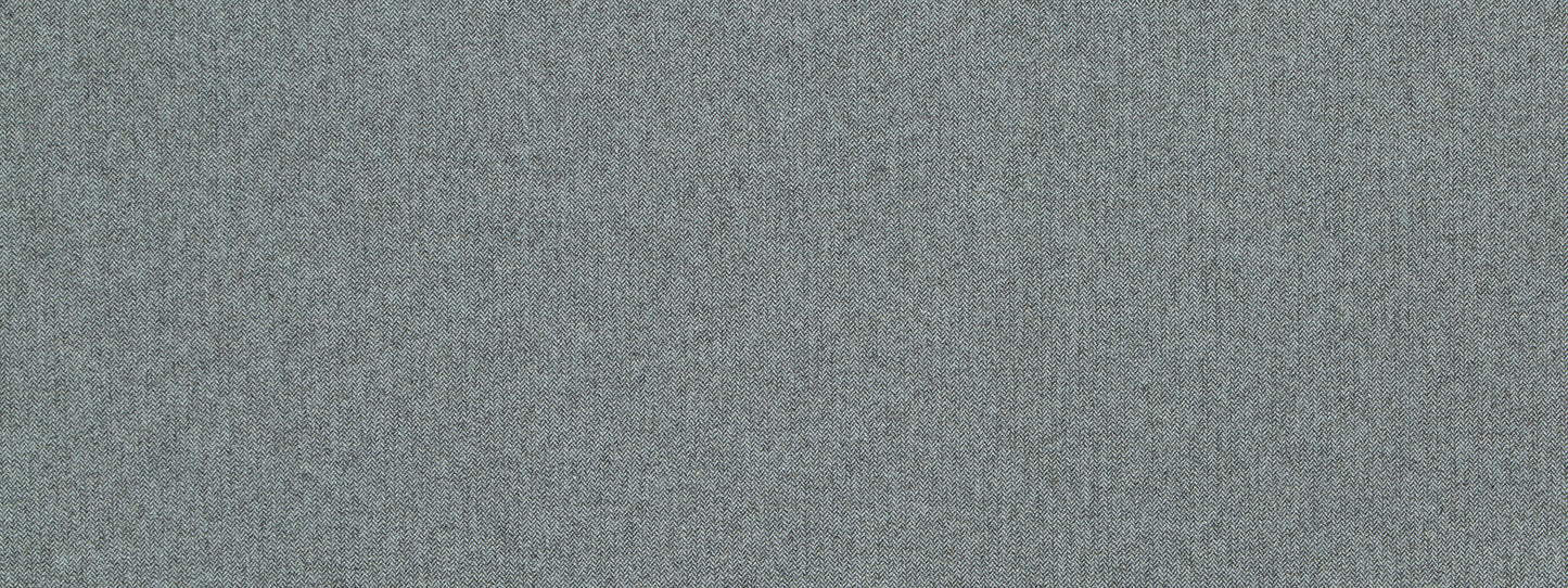Close-up of light gray wool chevron upholstery fabric texture.