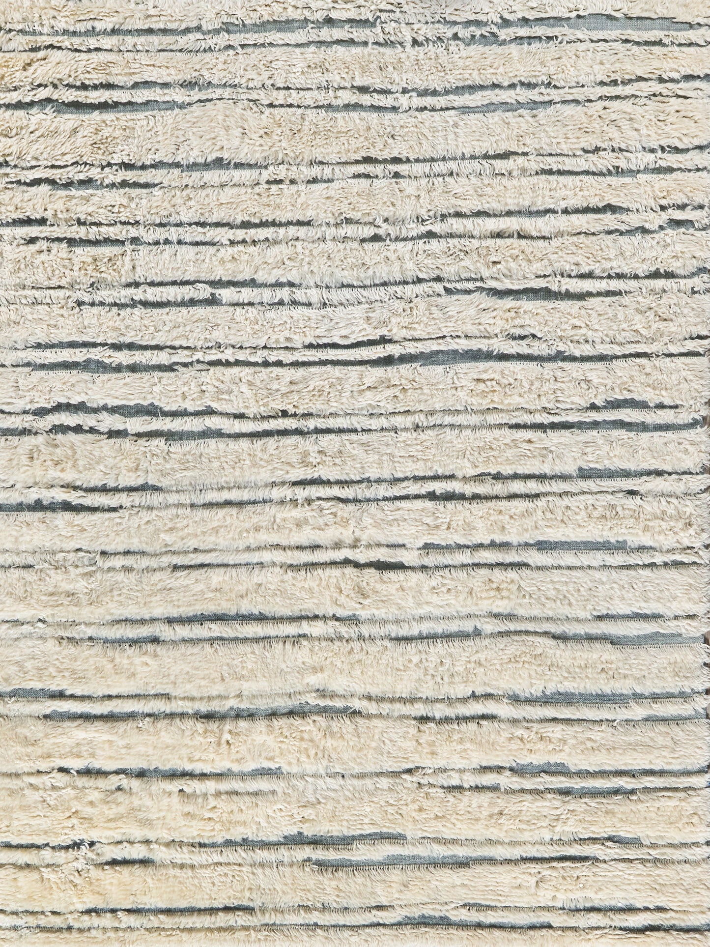 Beige Moroccan indoor hand-knotted rug with a textured weave and subtle shadows.
