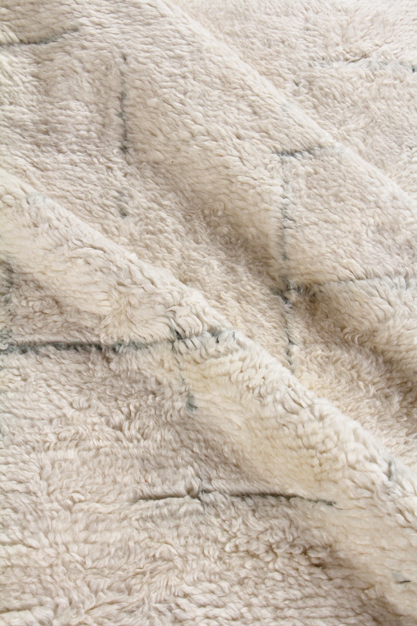 Beige Moroccan indoor hand-knotted rug close-up showing knotwork & soft pile.