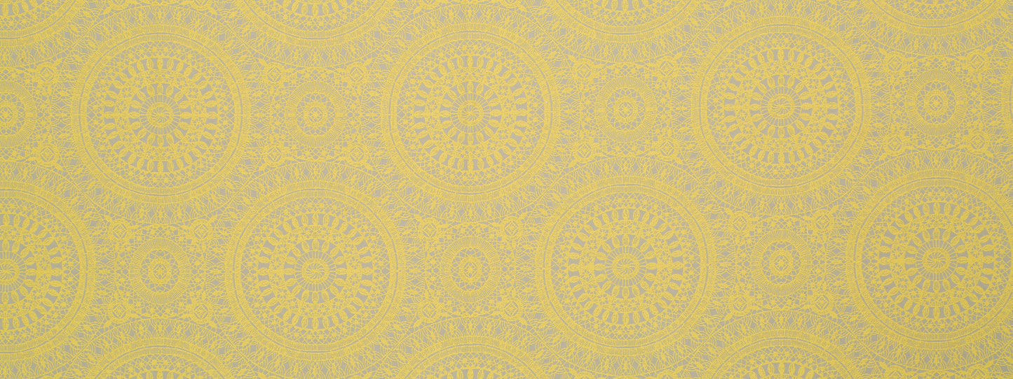 Golden-yellow textile pattern with repeating mandala circles and subtle texture