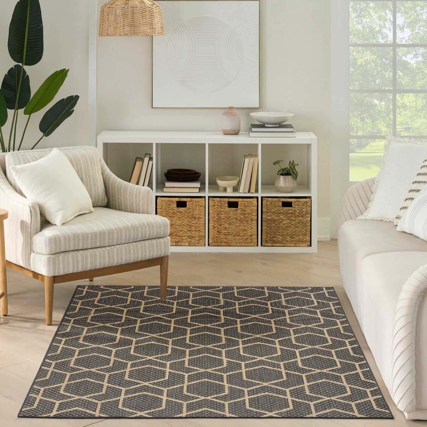Neutral living room with white cubby storage, woven baskets, beige striped armchair, white sofa, and a gray-beige hex rug.