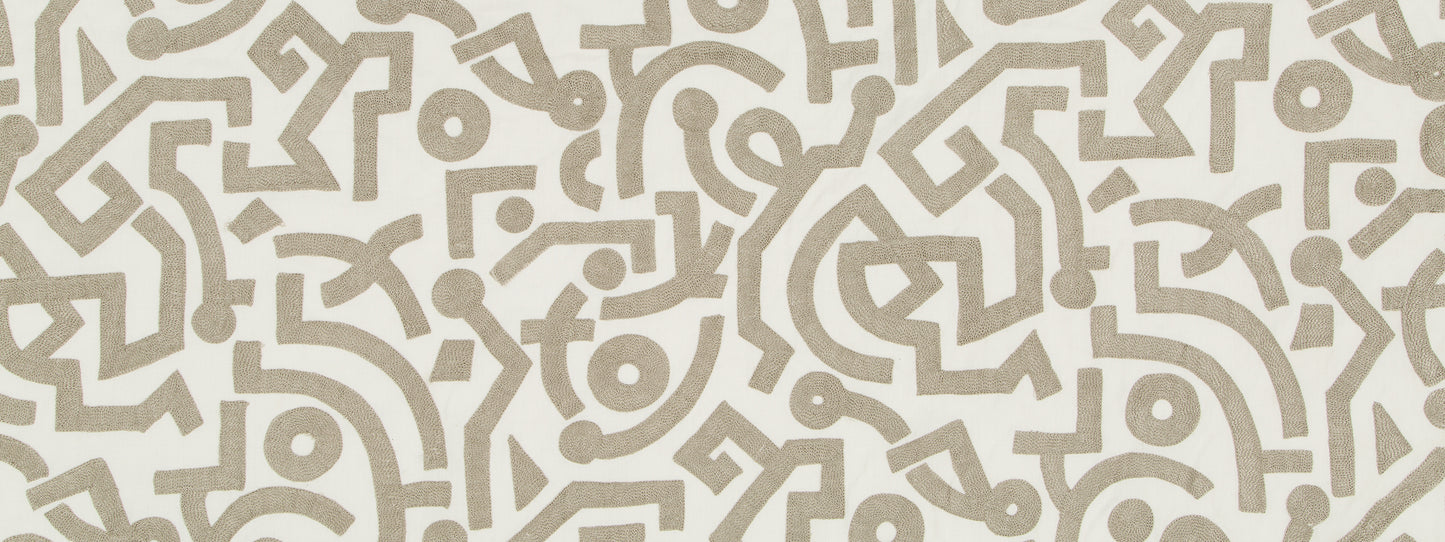 Beige taupe arabesque geometric pattern on cream background; decorative wallpaper or textile motif.